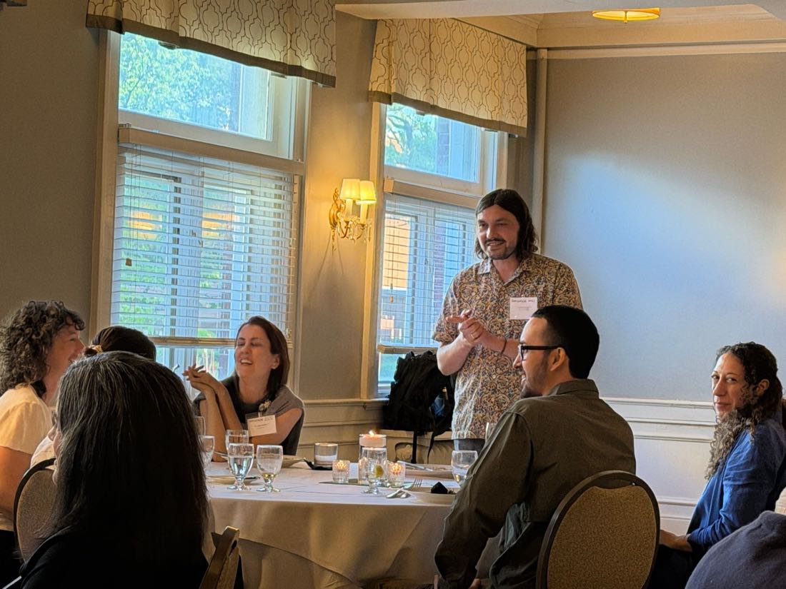 Fellows in discussion over dinner at the Great Questions Foundation gathering